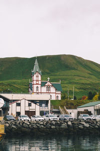 Houses by sea against sky