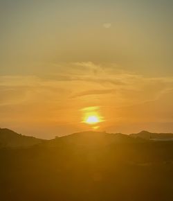 Scenic view of sunset over mountains