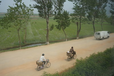 High angle view of men riding bicycles on country road