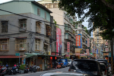 Cars on street by buildings in city