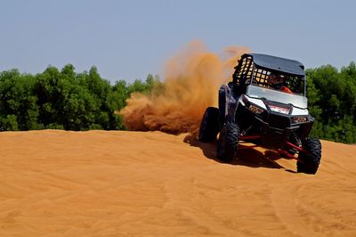 Truck on field against clear sky