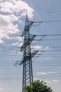 Low angle view of electricity pylon against sky