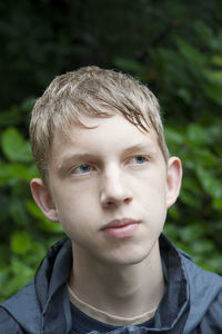 Close-up portrait of boy in rain