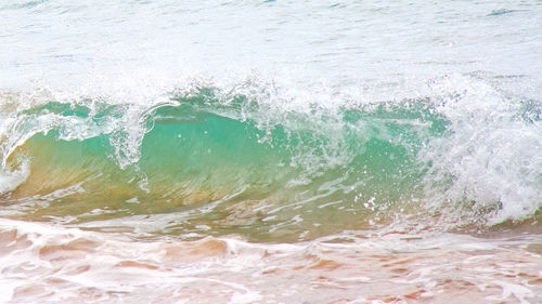 Close-up of wave splashing on beach