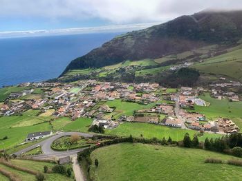 Scenic view of sea and buildings against sky