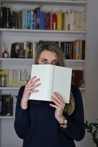 Midsection of woman reading book