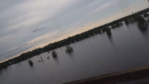 Scenic view of lake against sky at sunset