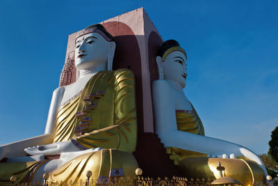 Giant seated buddhas at kyaik pun pagoda, bago, myanmar