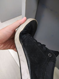 Low section of person holding broke shoe
