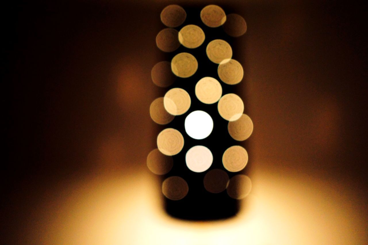 indoors, still life, close-up, in a row, large group of objects, circle, studio shot, repetition, selective focus, order, illuminated, arrangement, pattern, no people, metal, abundance, shape, geometric shape, variation, light - natural phenomenon