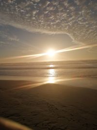 Scenic view of beach against sky during sunset