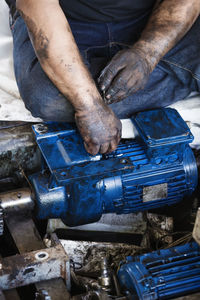 Close-up of man fixing machinery