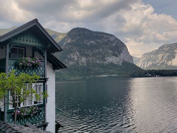 Scenic view of lake by mountains against sky