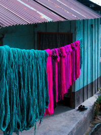 Textiles on rope drying on rope outside house