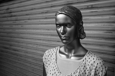 Mannequin in display against shutter