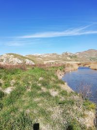 Scenic view of landscape against blue sky