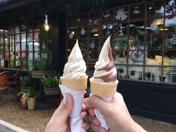 Cropped hands of people holding ice cream