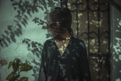 Woman standing against wall