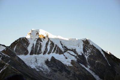 Scenic view of snowcapped mountains against clear sky