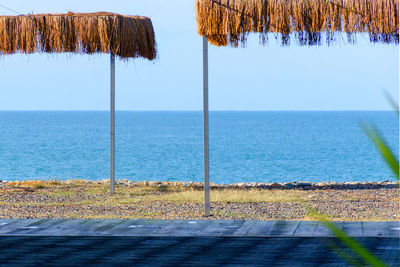 View of the sea beach with thatched canopies. travel background