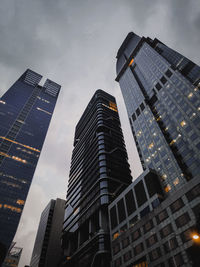 Low angle view of modern buildings against sky at dusk