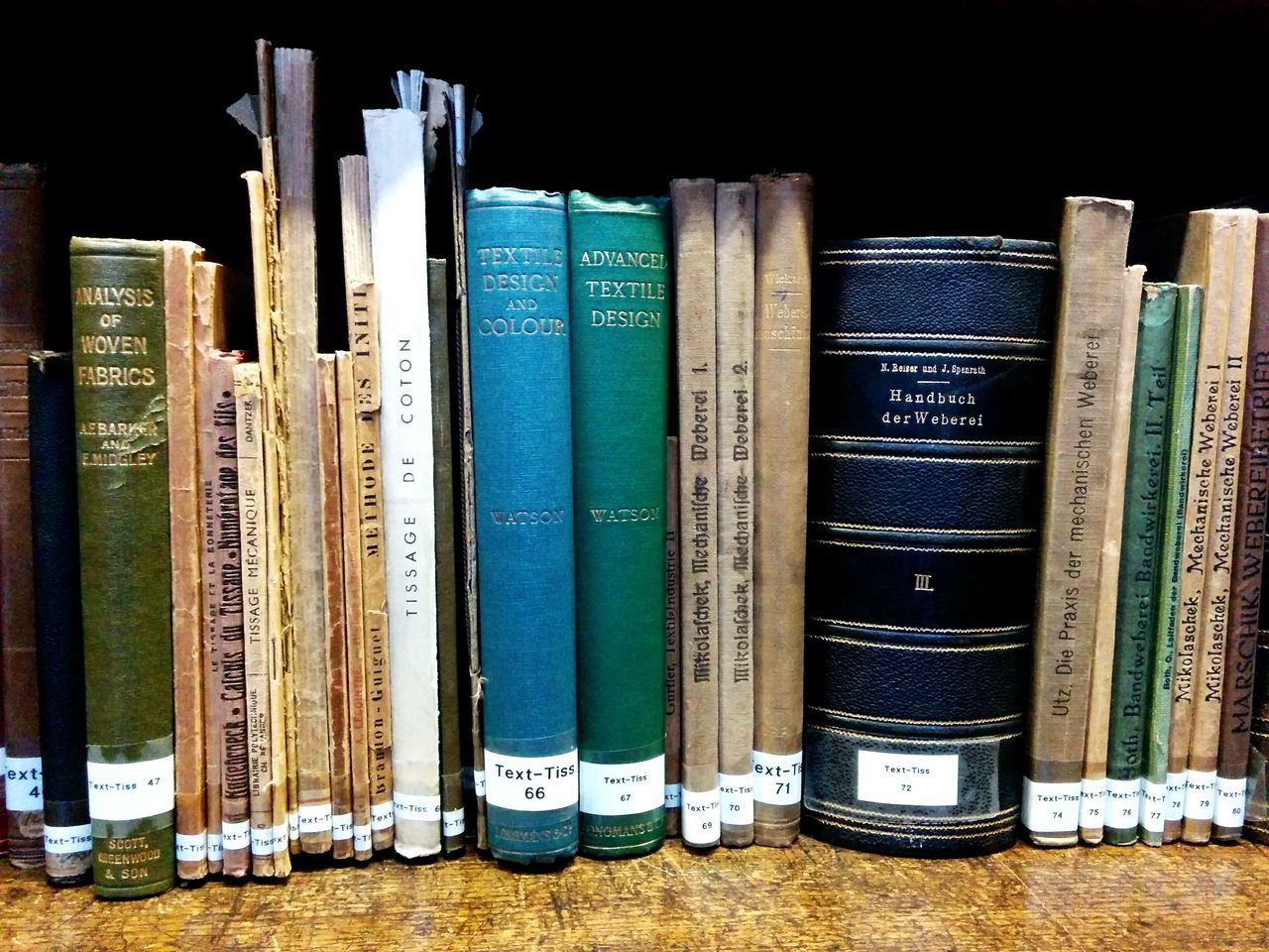 large group of objects, indoors, text, still life, variation, education, arrangement, western script, abundance, in a row, communication, order, choice, wood - material, no people, side by side, stack, close-up, book, high angle view