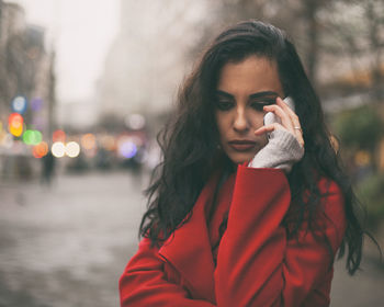 Young woman talking on mobile phone in city