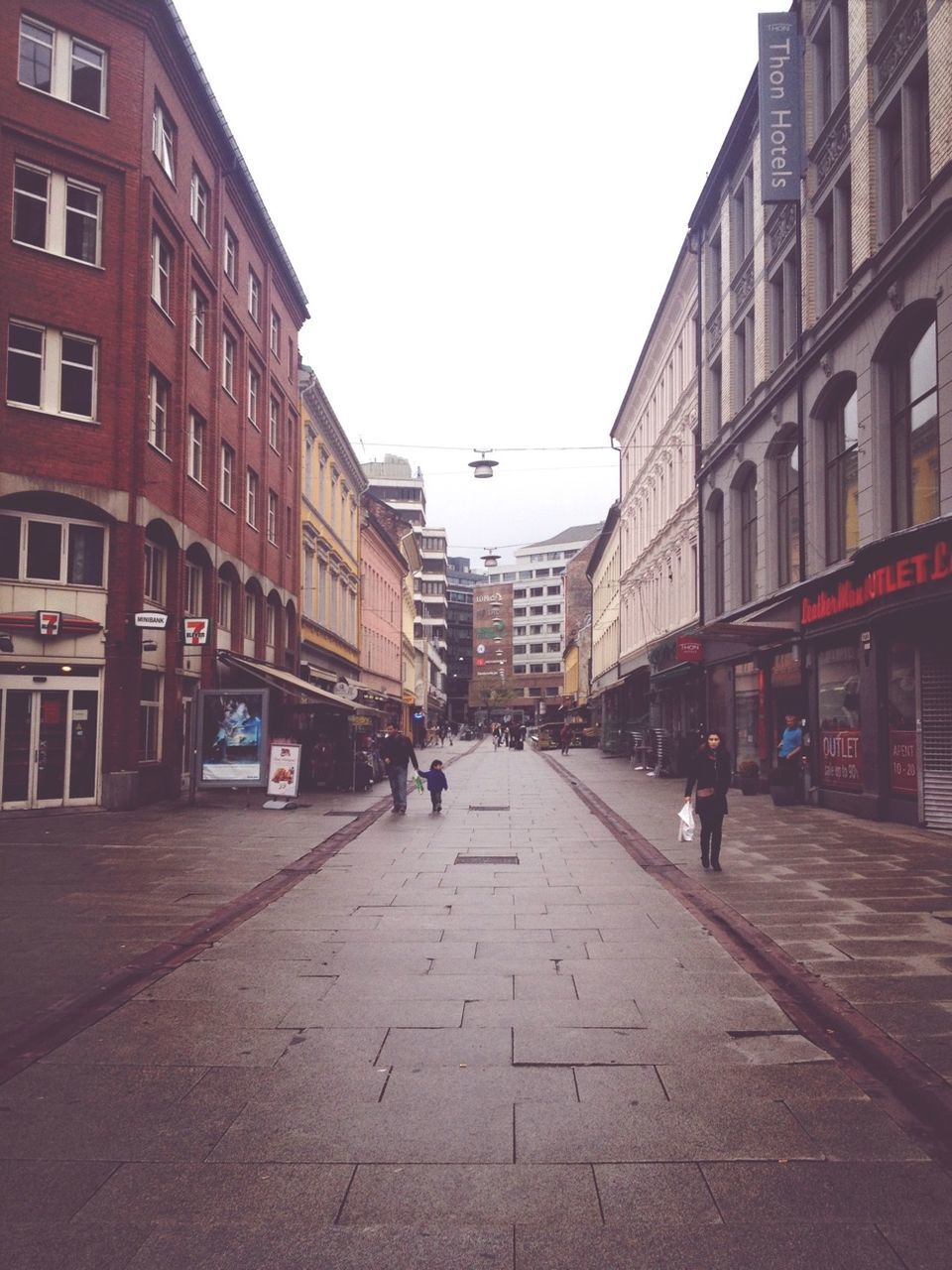 building exterior, architecture, built structure, street, city, clear sky, men, walking, the way forward, transportation, city life, person, lifestyles, building, large group of people, incidental people, city street, diminishing perspective, road