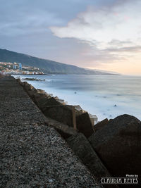 Scenic view of sea against cloudy sky