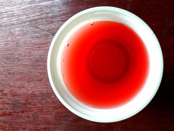 Directly above shot of red drink on table