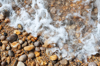 Full frame shot of pebbles on shore