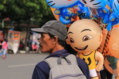Close-up of man with balloons