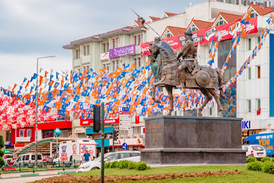 Low angle view of flags hanging on building against sky