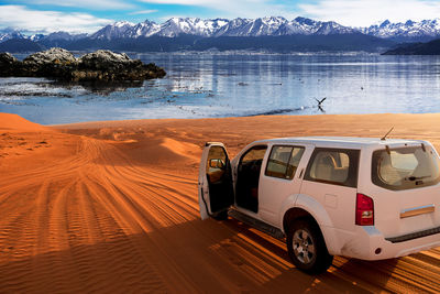 View of car on beach against sky