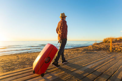 Man standing on beach against sky