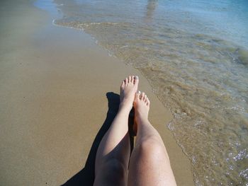 Low section of woman legs on beach