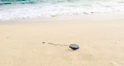 High angle view of abandoned wires at sandy beach