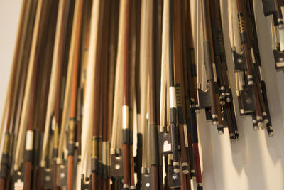 Low angle view of violin bows hanging at store