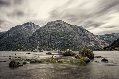 Scenic view of lake and mountains against sky