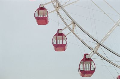 Close-up of amusement park ride against sky