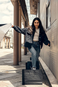 Happy young woman rejoices in good shopping. girl with shopping bags.