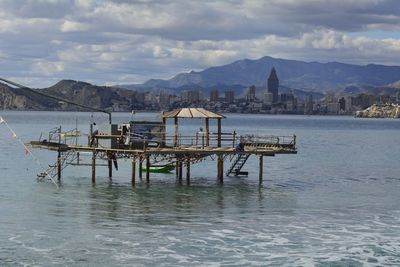 Scenic view of mountain range against cloudy sky