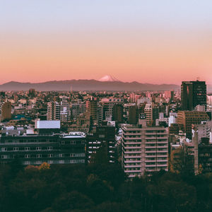 Cityscape against clear sky during sunset