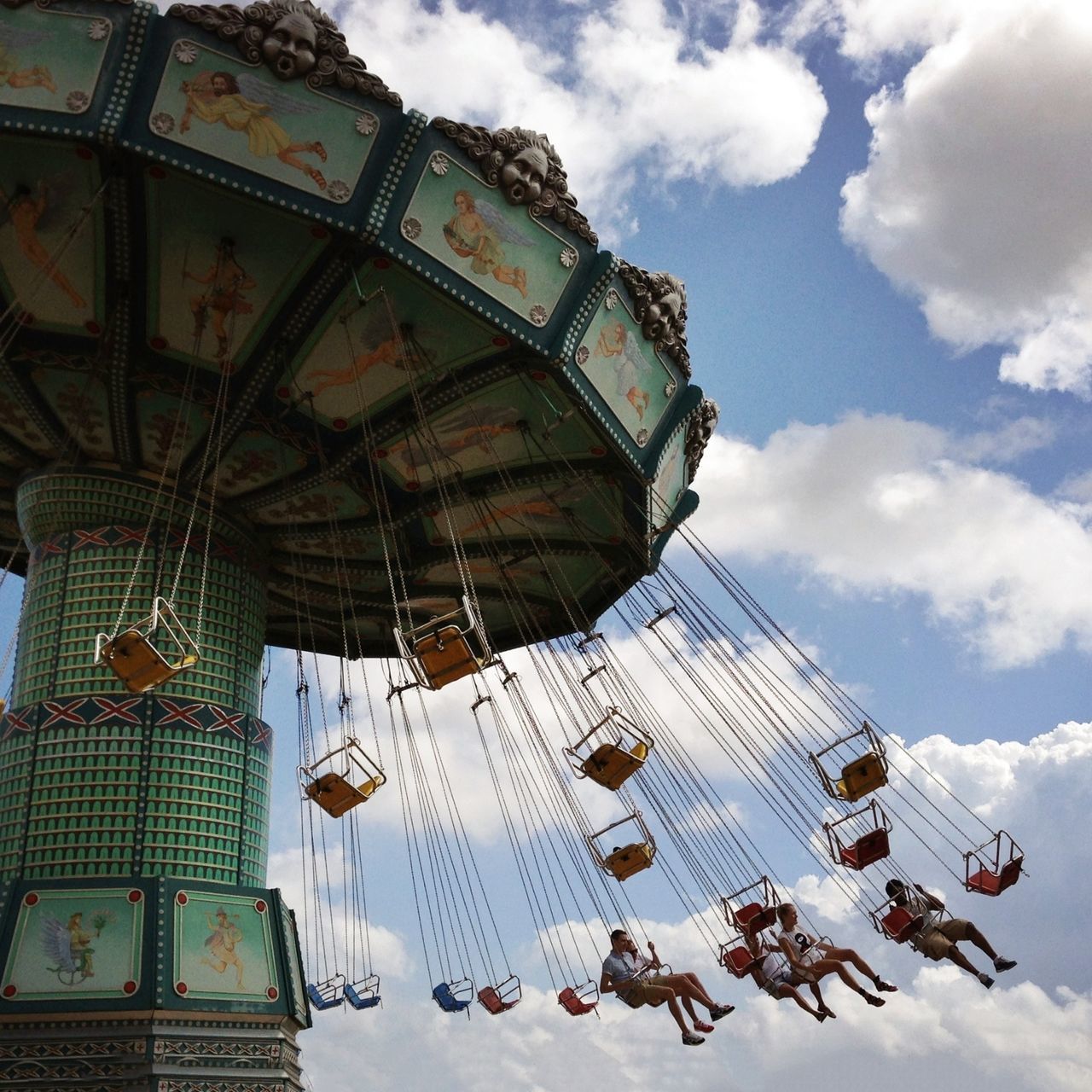 amusement park, low angle view, amusement park ride, sky, architecture, arts culture and entertainment, built structure, ferris wheel, famous place, building exterior, cloud - sky, travel destinations, tourism, international landmark, travel, leisure activity, capital cities, fun, day