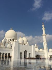 Low angle view of sheikh zayed mosque against cloudy sky