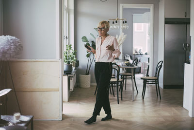 Woman working at home on the phone having a conversation