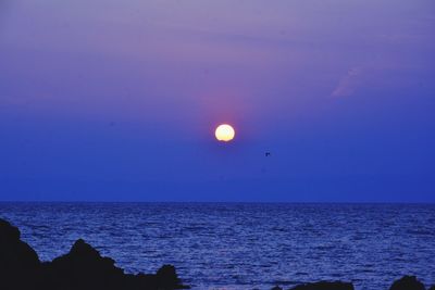 Scenic view of sea against sky at sunset