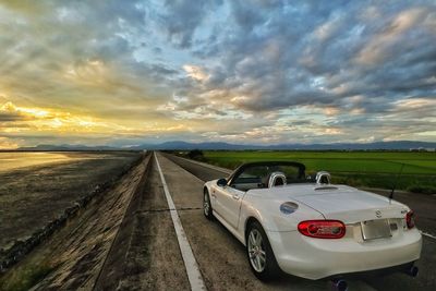 Cars on road in city during sunset