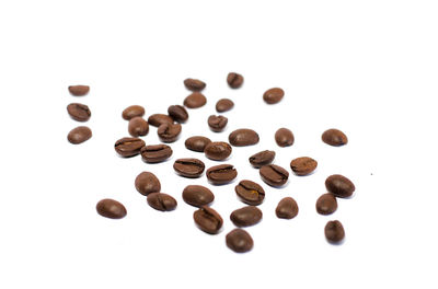 Close-up of coffee beans against white background