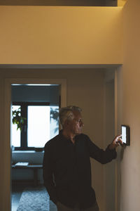 Senior man using tablet pc at smart home